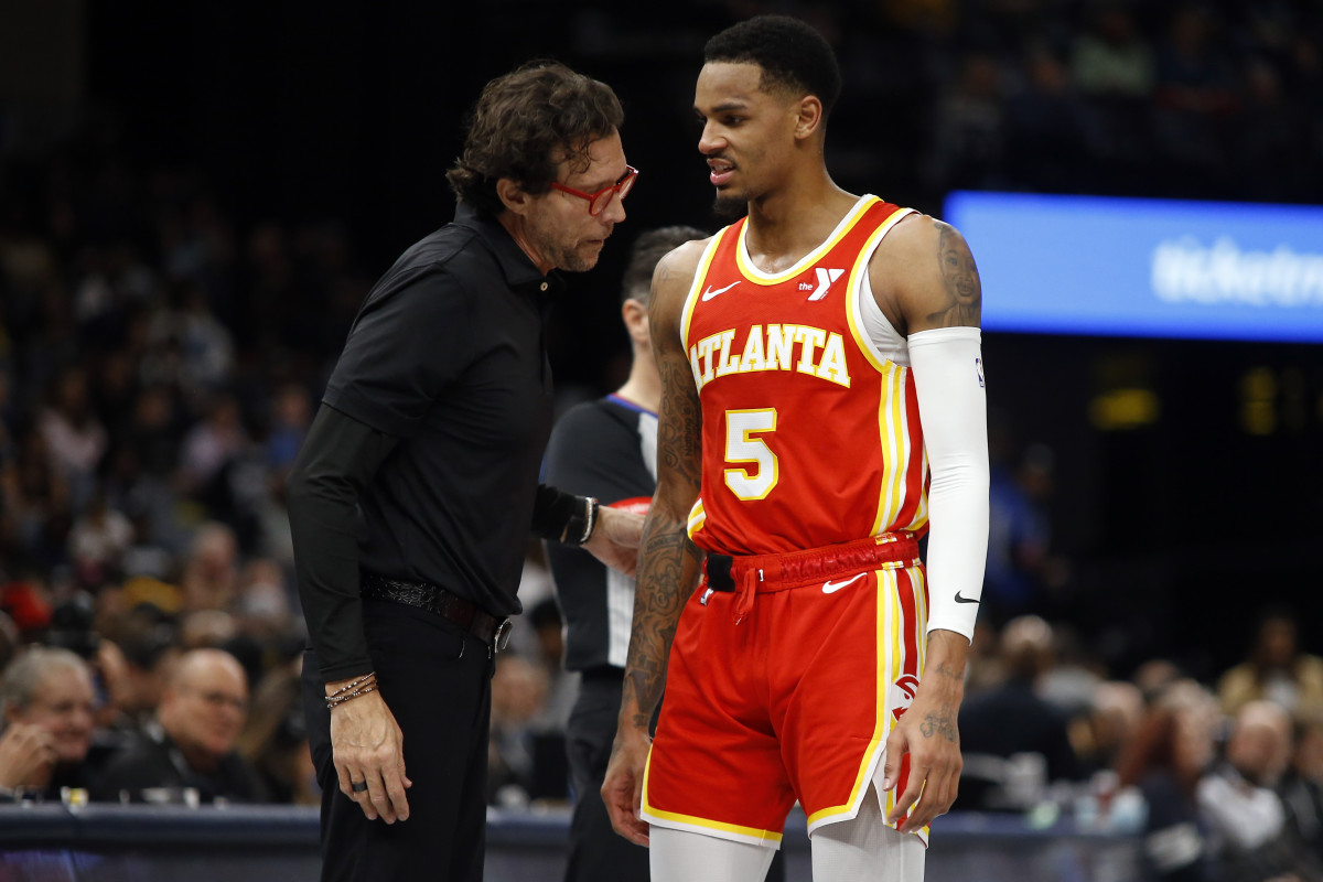 Mar 8, 2024; Memphis, Tennessee, USA; Atlanta Hawks head coach Quin Snyder (left) talks with Atlanta Hawks guard Dejounte Murray (5) during the first half against the Memphis Grizzlies at FedExForum. Mandatory Credit: Petre Thomas-USA TODAY Sports